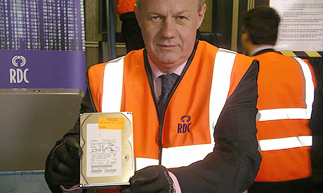 Minister Damian Green shows an ID card hard drive ready to be destroyed